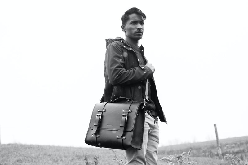grayscale picture model wearing Oldenburg large leather messenger bag 