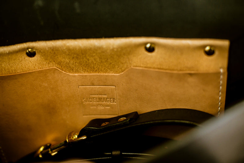 inside of oldenburg medium leather messenger bag in black with brass buckles  