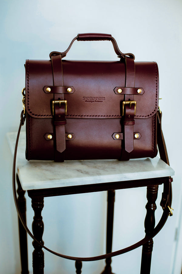 oldenburg small leather messenger bag in oxblood with brass buckles  