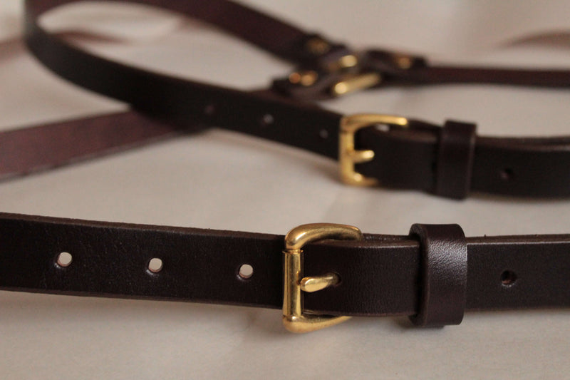 Closeup of Sadelmager dark brown Leather Fjord suspenders brass buckles