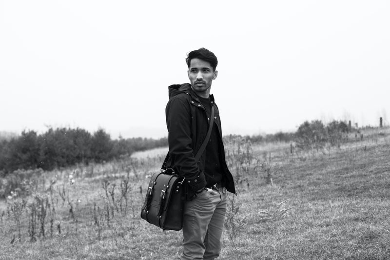 grayscale picture model wearing Oldenburg large leather messenger bag 