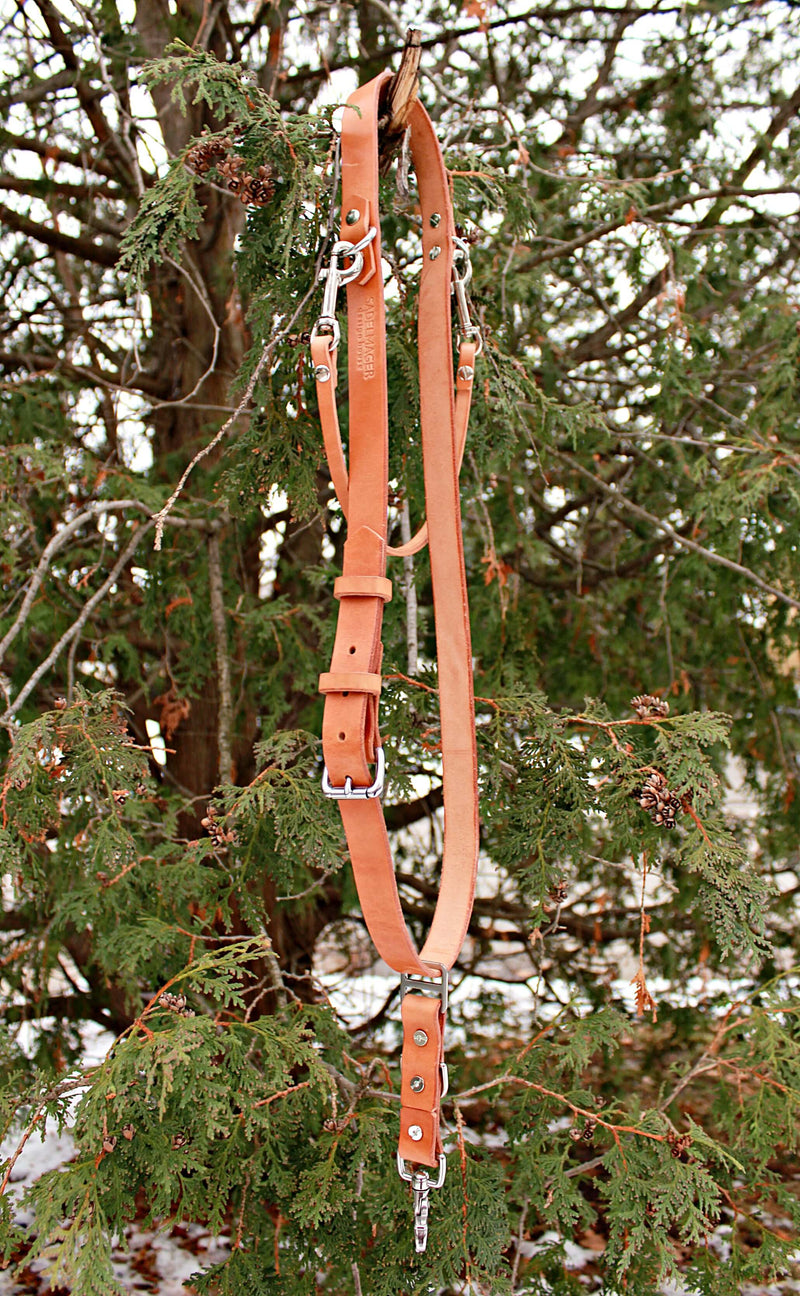 Sadelmager Leather Fjord Crossbody camera strap hung up on tree