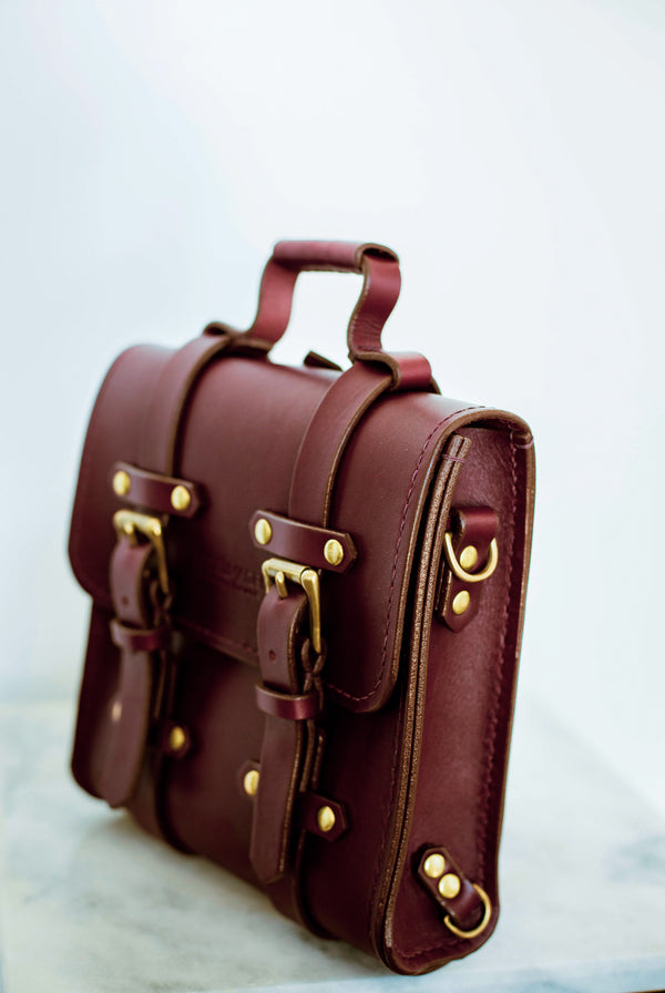 oxblood Sadelmager campus messenger with brass buckles tilted right