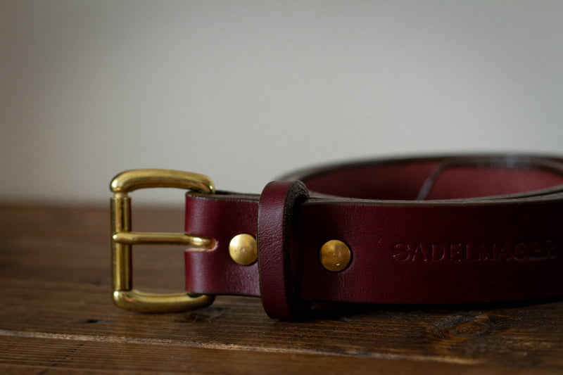 red and brass leather saddle maker belt