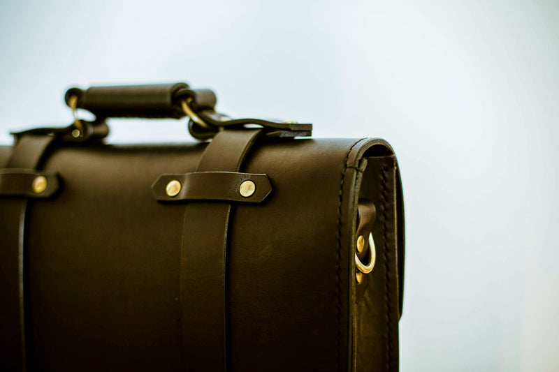 back side oldenburg medium leather messenger bag in black with brass buckles  