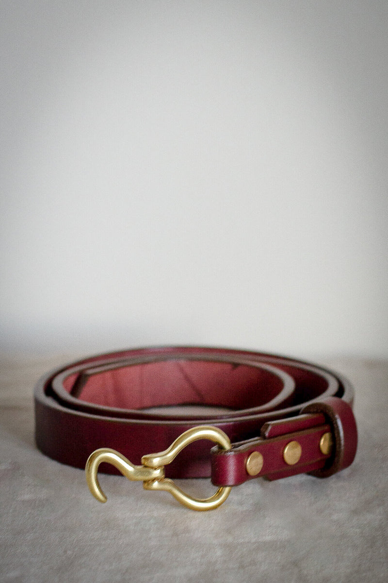 small hook style belt hoofpick with red oxblood leather and solid brass made in canada