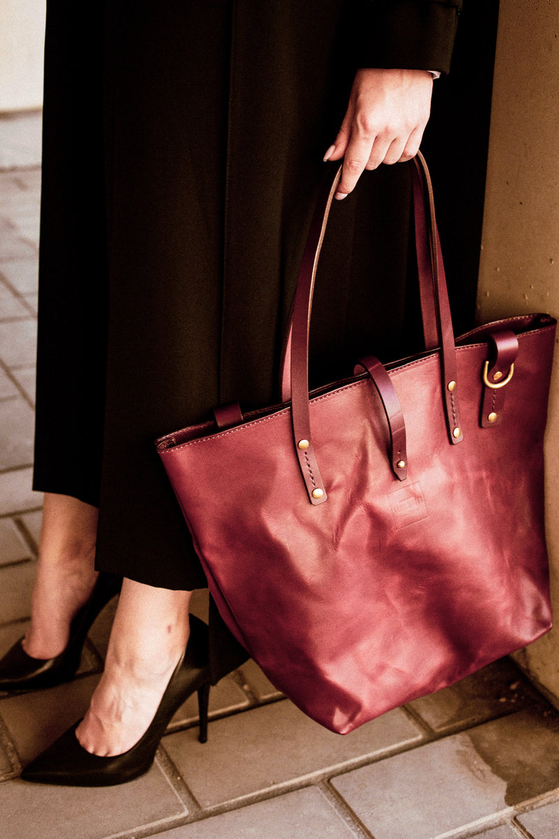 model holding Shire leather tote bag in oxblood made in canada crossbody