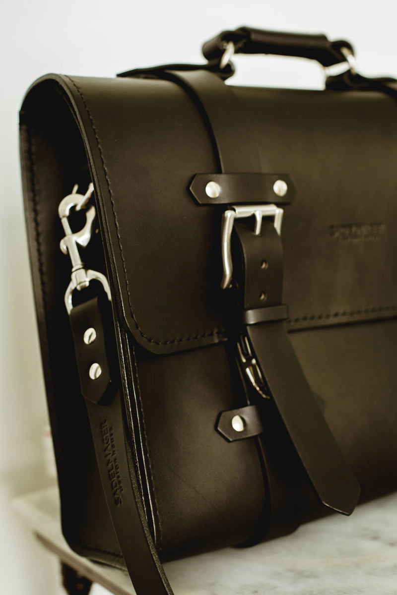 left side Oldenburg large leather messenger bag in black with stainless steel buckles 
