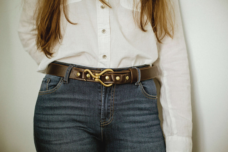 close up of model wearing leather shire belt 1-1/4" in dark brown with brass hook