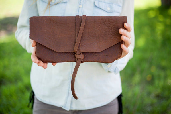 model holding welsh leather clutch dark brown 