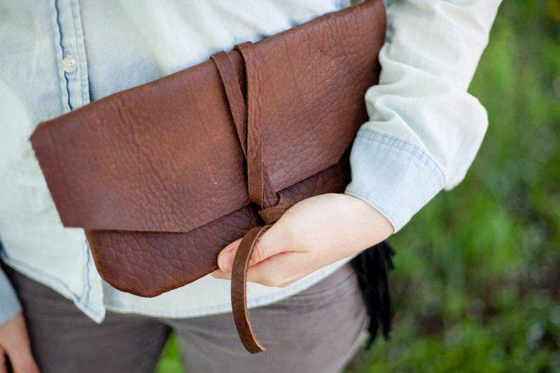  women holding welsh leather clutch in dark brown